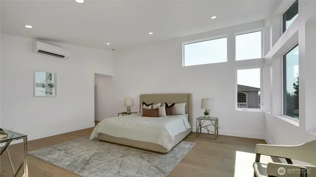 a bedroom with a large bed and a window