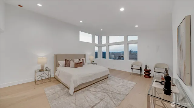 a bedroom with a large bed and a large window