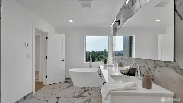 a bathroom with a sink vanity and mirror