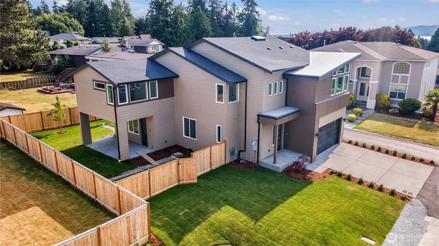 a aerial view of a house with swimming pool and a yard