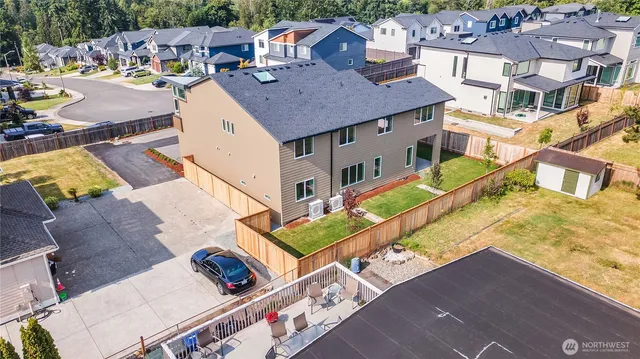 an aerial view of a house with a yard