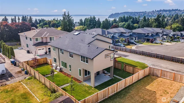 an aerial view of a house with a big yard