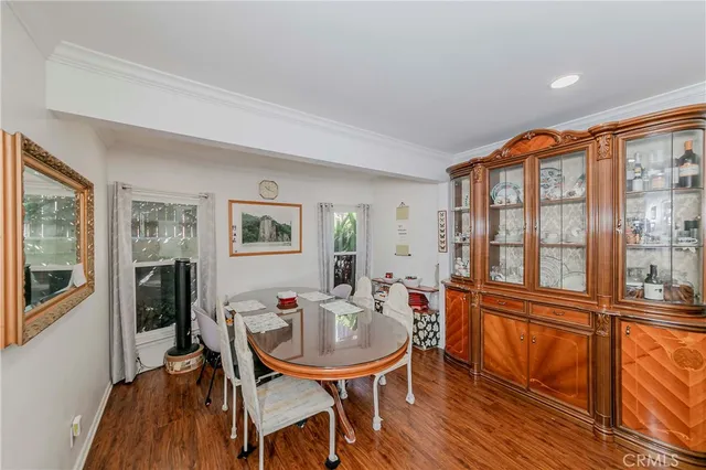 a dining room with furniture window and wooden floor