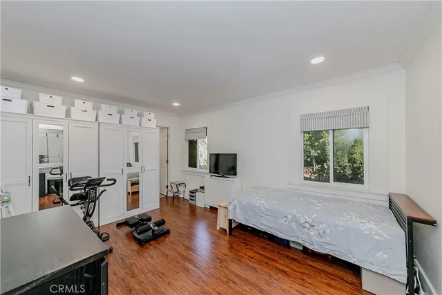 a living room with furniture window and a wooden floor