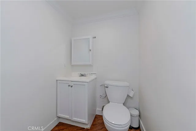 a white toilet sitting next to a bathroom sink