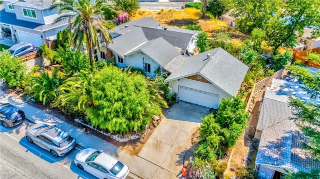 an aerial view of a house with a yard and garden