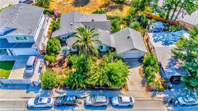 an aerial view of a house with a yard and garden