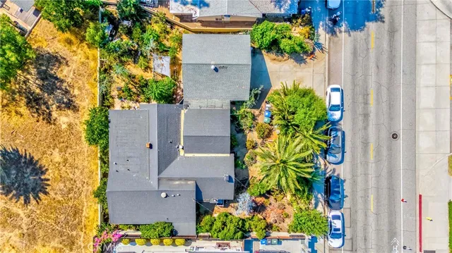 an aerial view of a house with a yard and garden