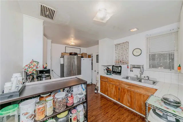 a kitchen with stainless steel appliances kitchen island granite countertop a sink stove and cabinets