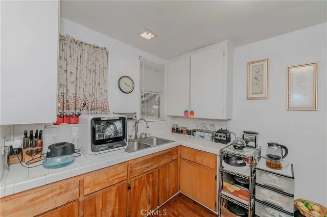 a kitchen with stainless steel appliances a stove a sink and cabinets