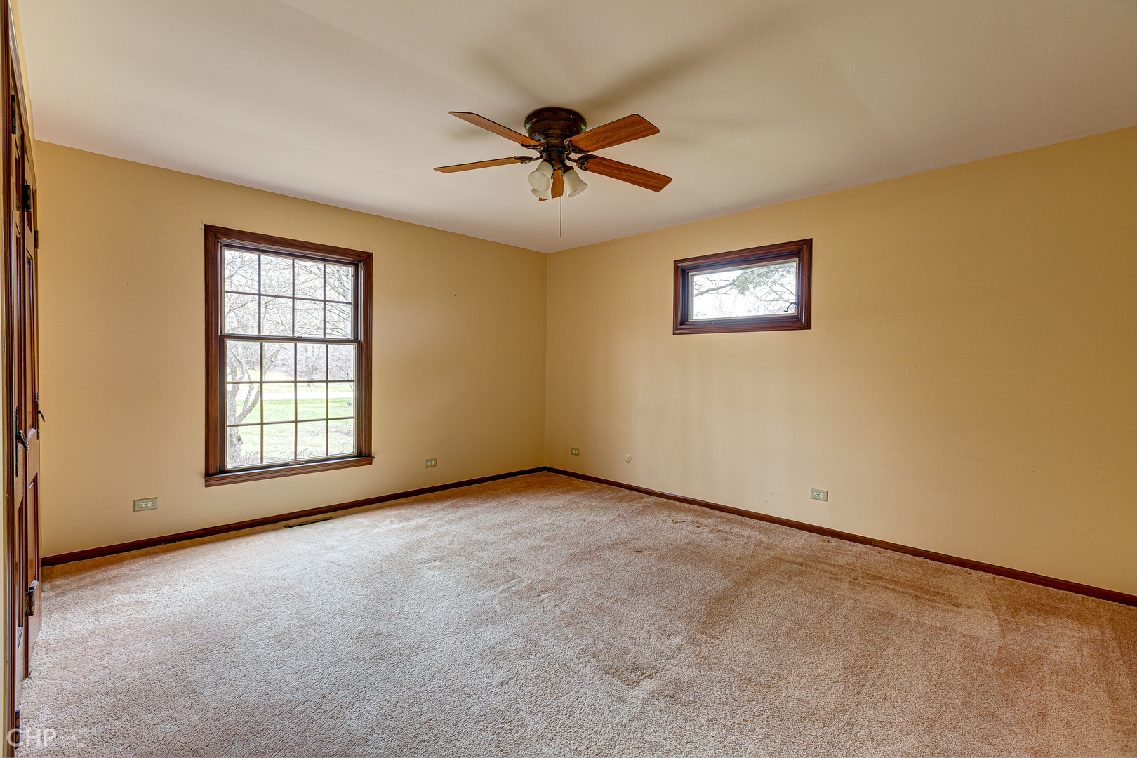 3027 Red Barn Road Crystal Lake, IL 60012 - Photo 14 of 40 an empty room with windows and ceiling fan