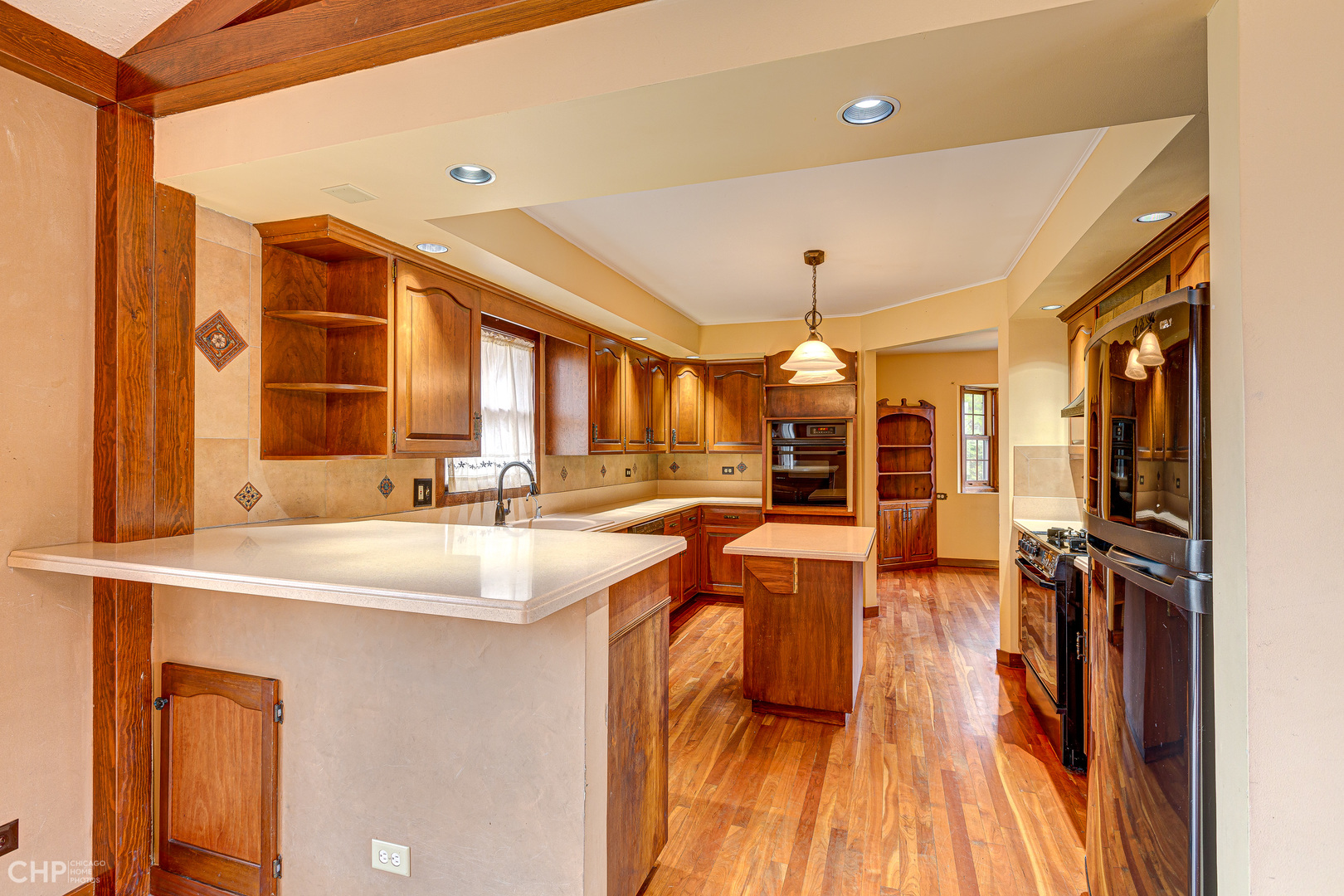 3027 Red Barn Road Crystal Lake, IL 60012 - Photo 6 of 40 a view of a kitchen with kitchen island granite countertop a large window and a sink