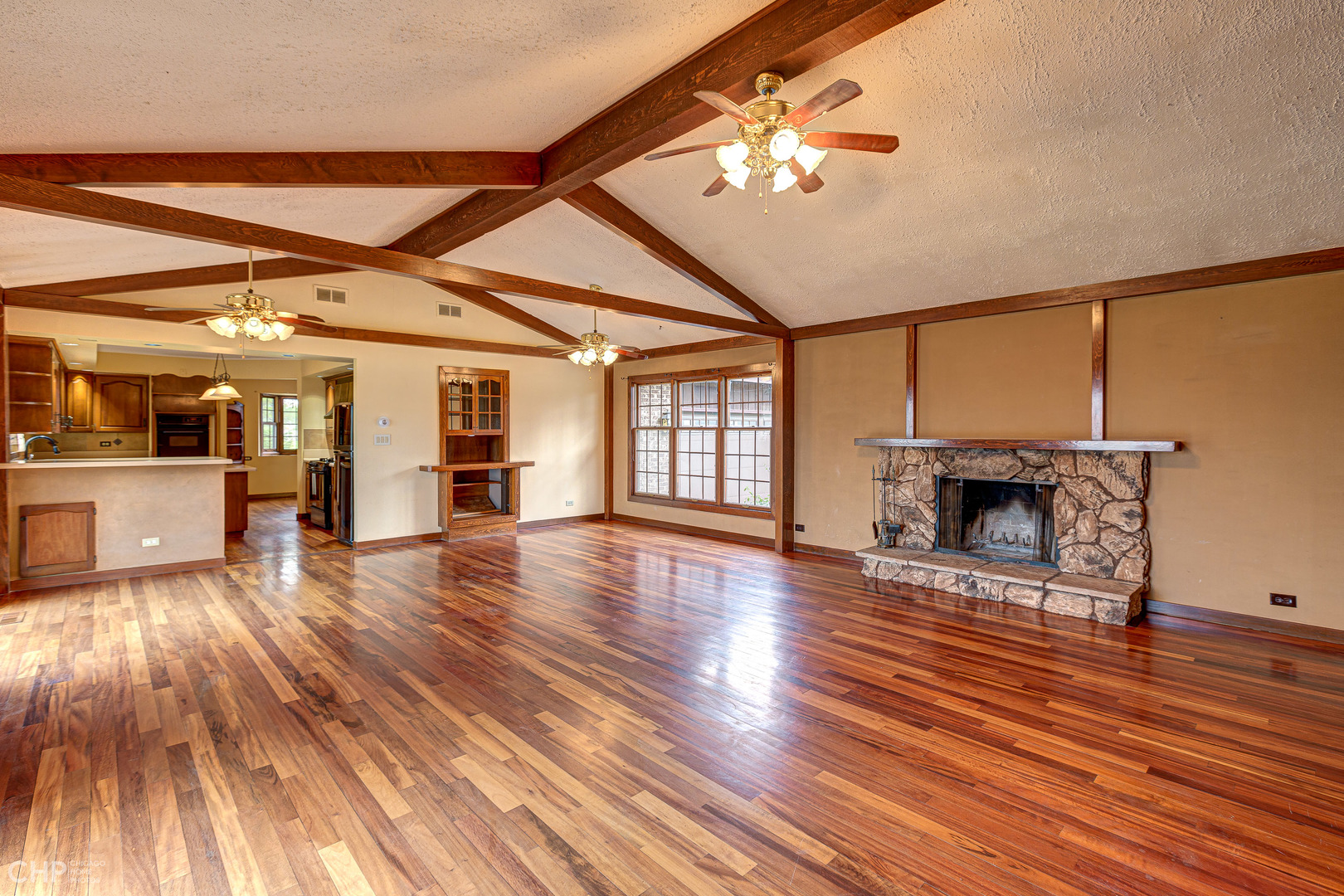 3027 Red Barn Road Crystal Lake, IL 60012 - Photo 7 of 40 a view of a livingroom with wooden floor and a ceiling fan