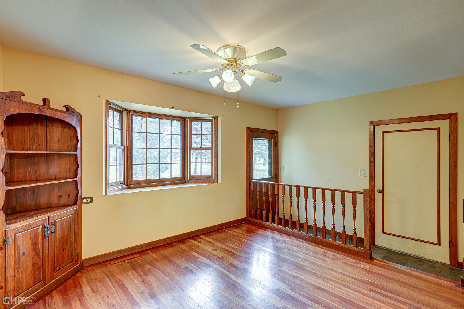 3027 Red Barn Road Crystal Lake, IL 60012 - Photo 10 of 40 a view of an empty room with window and wooden floor