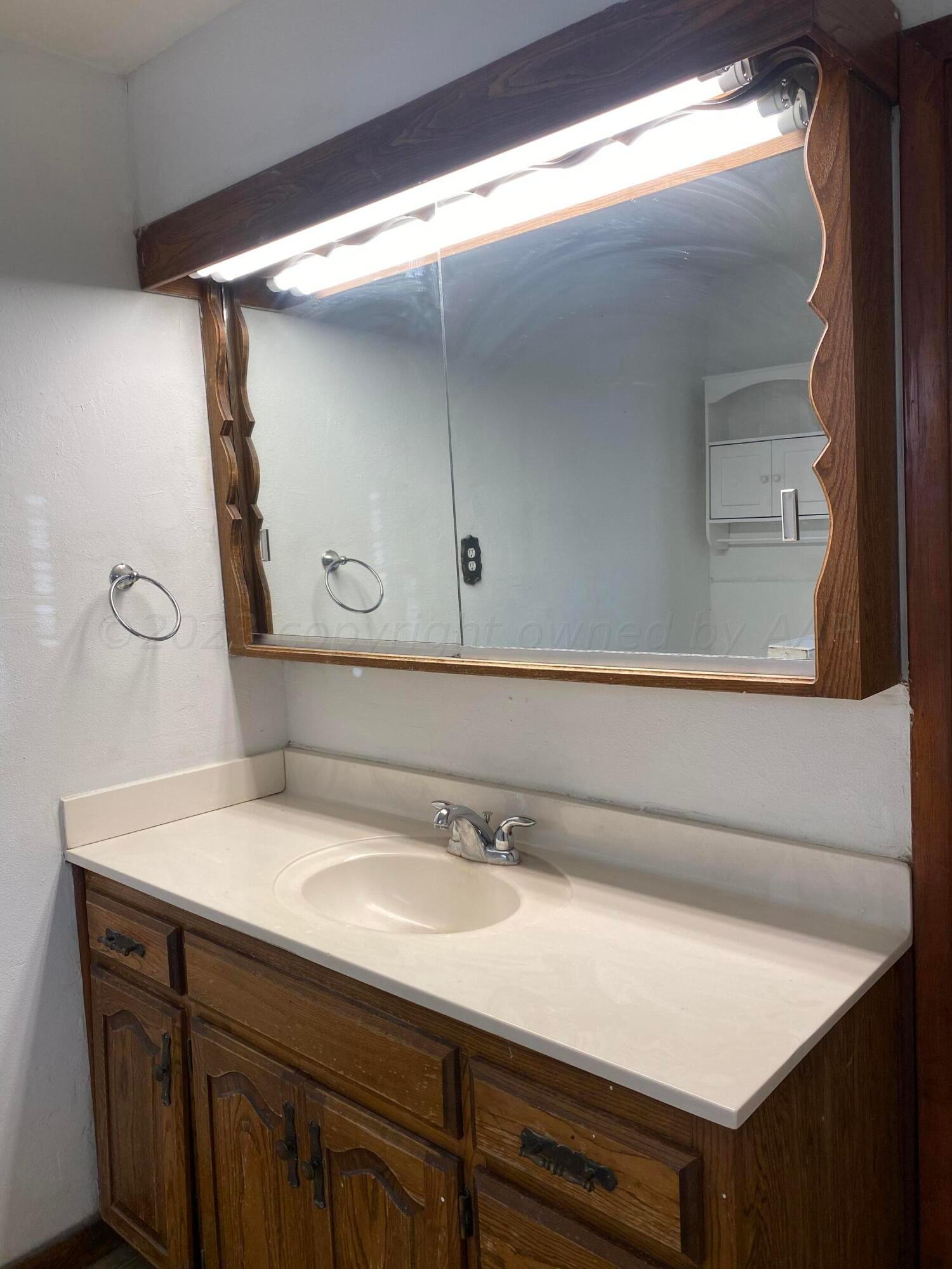 310 Santa Fe Street Borger, TX 79007 - Photo 12 of 18 a bathroom with a sink and a mirror