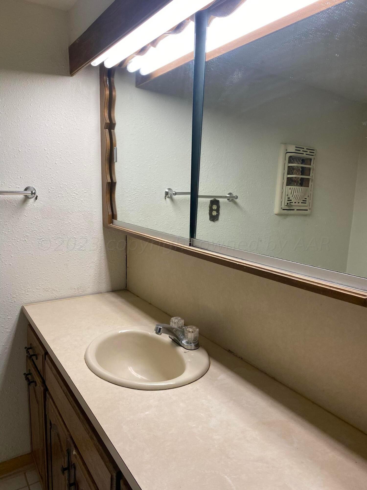 310 Santa Fe Street Borger, TX 79007 - Photo 15 of 18 a bathroom with a sink and a mirror