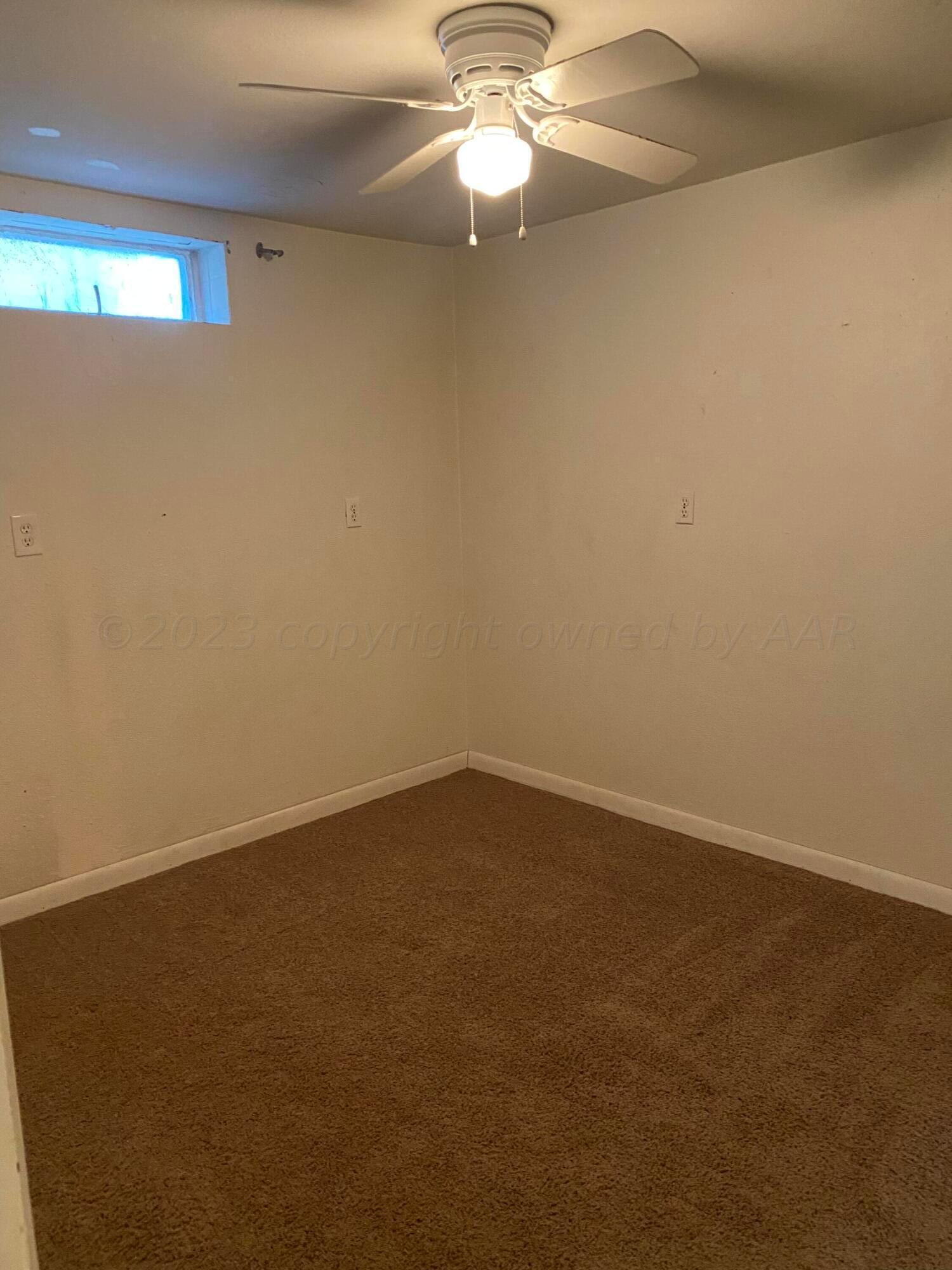 310 Santa Fe Street Borger, TX 79007 - Photo 17 of 18 an empty room with a fan and a window