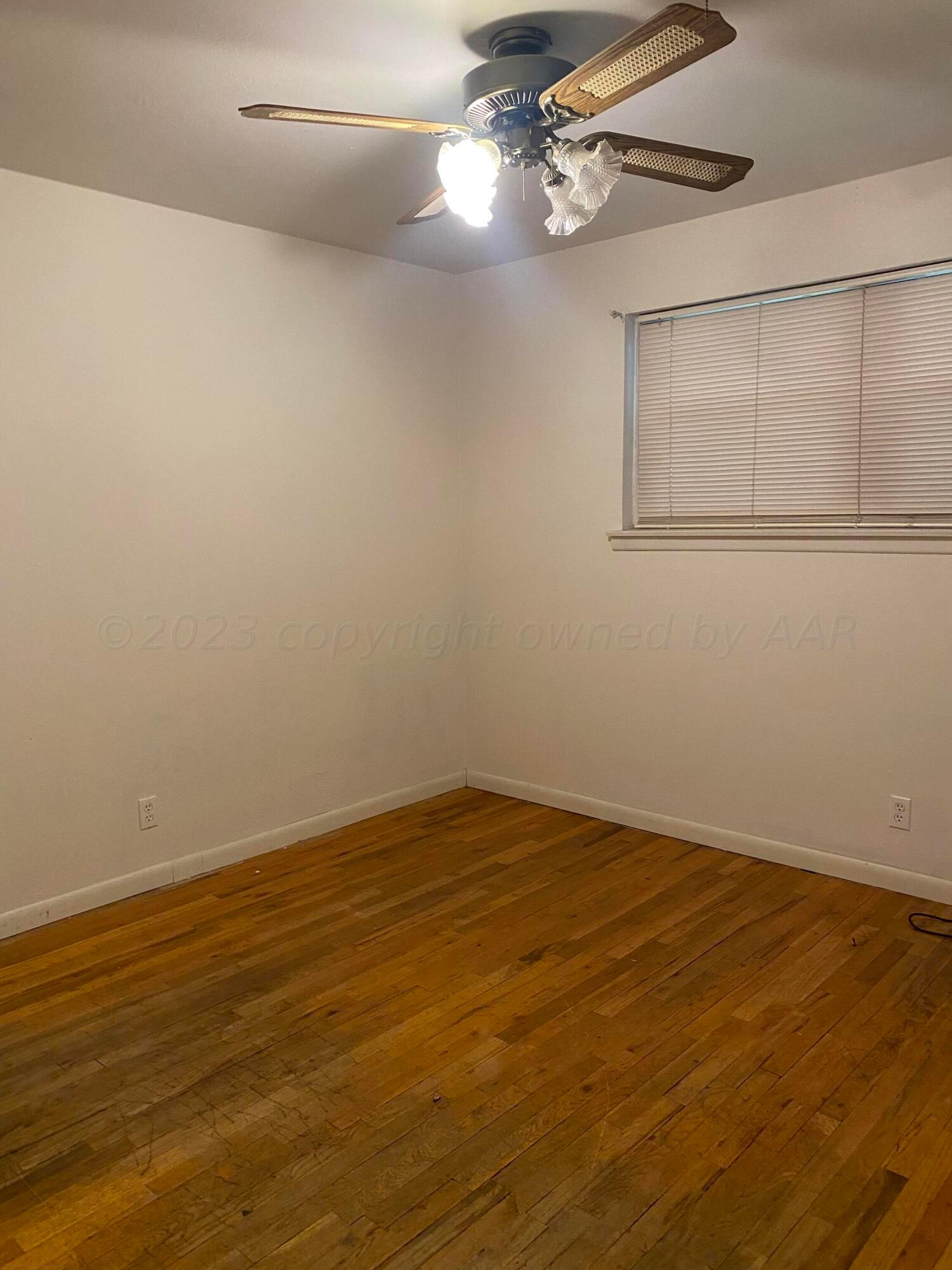 310 Santa Fe Street Borger, TX 79007 - Photo 7 of 18 a view of empty room with wooden floor