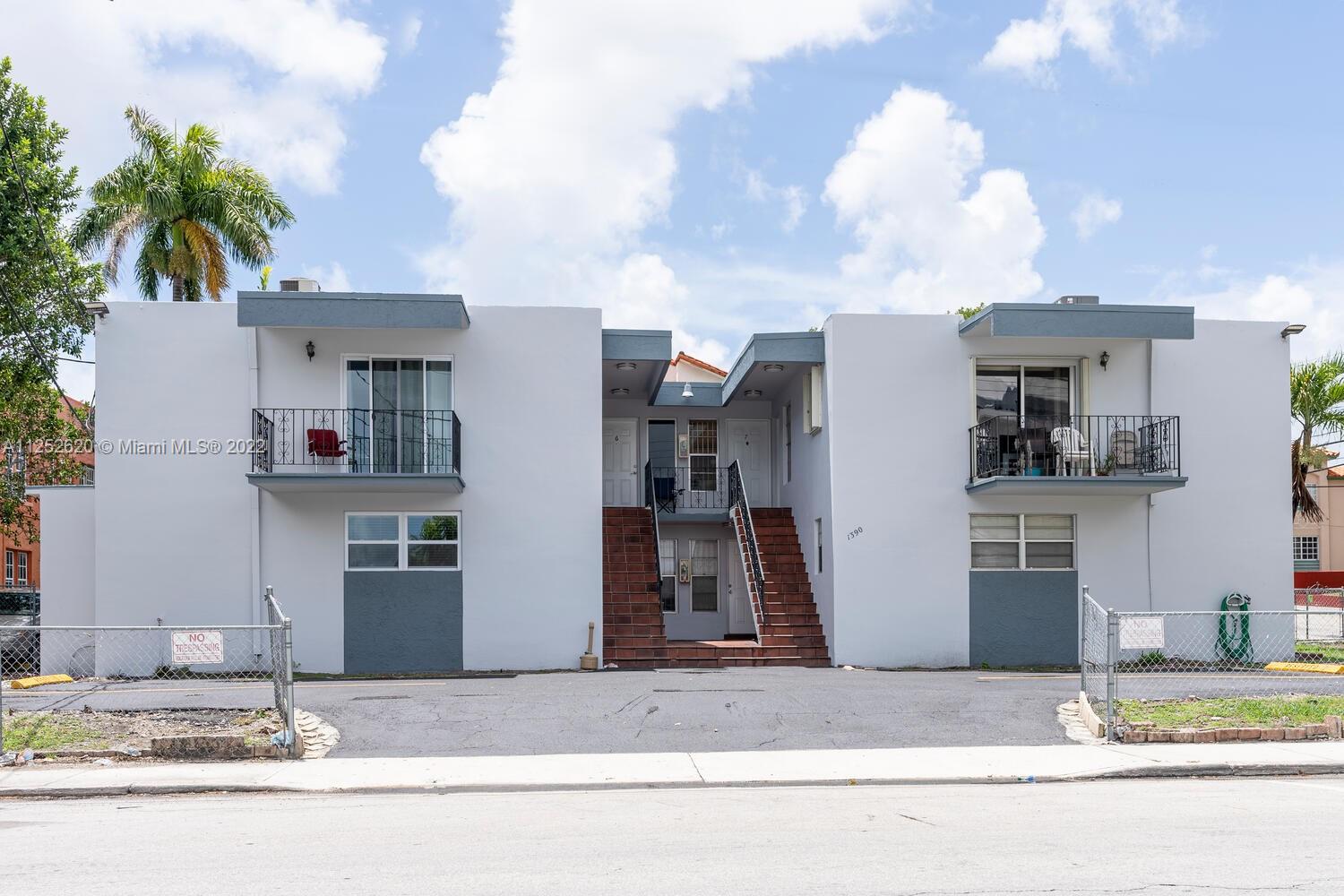 1390 Northwest 2nd Street, Unit 2 Miami, FL 33125 - Photo 1 of 10 a white building with trees in the background