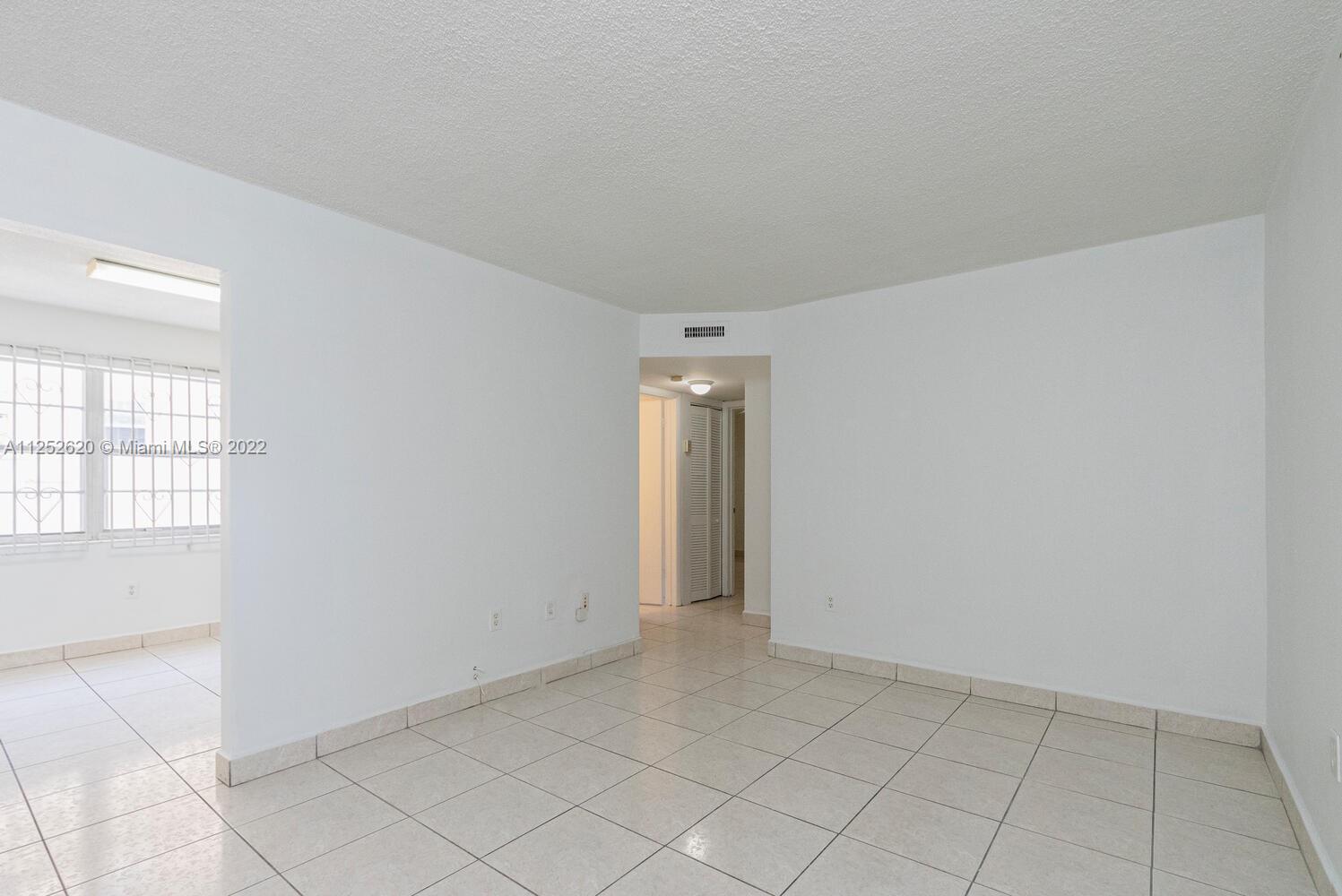 1390 Northwest 2nd Street, Unit 2 Miami, FL 33125 - Photo 4 of 10 an empty room with windows