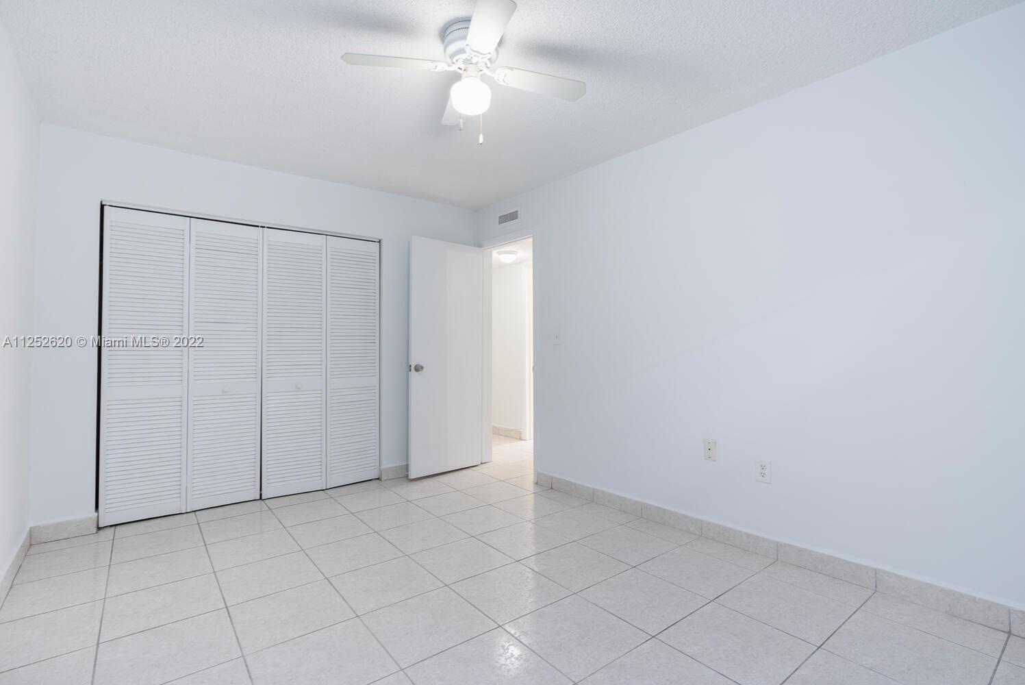 1390 Northwest 2nd Street, Unit 2 Miami, FL 33125 - Photo 7 of 10 an empty room with closet and fan