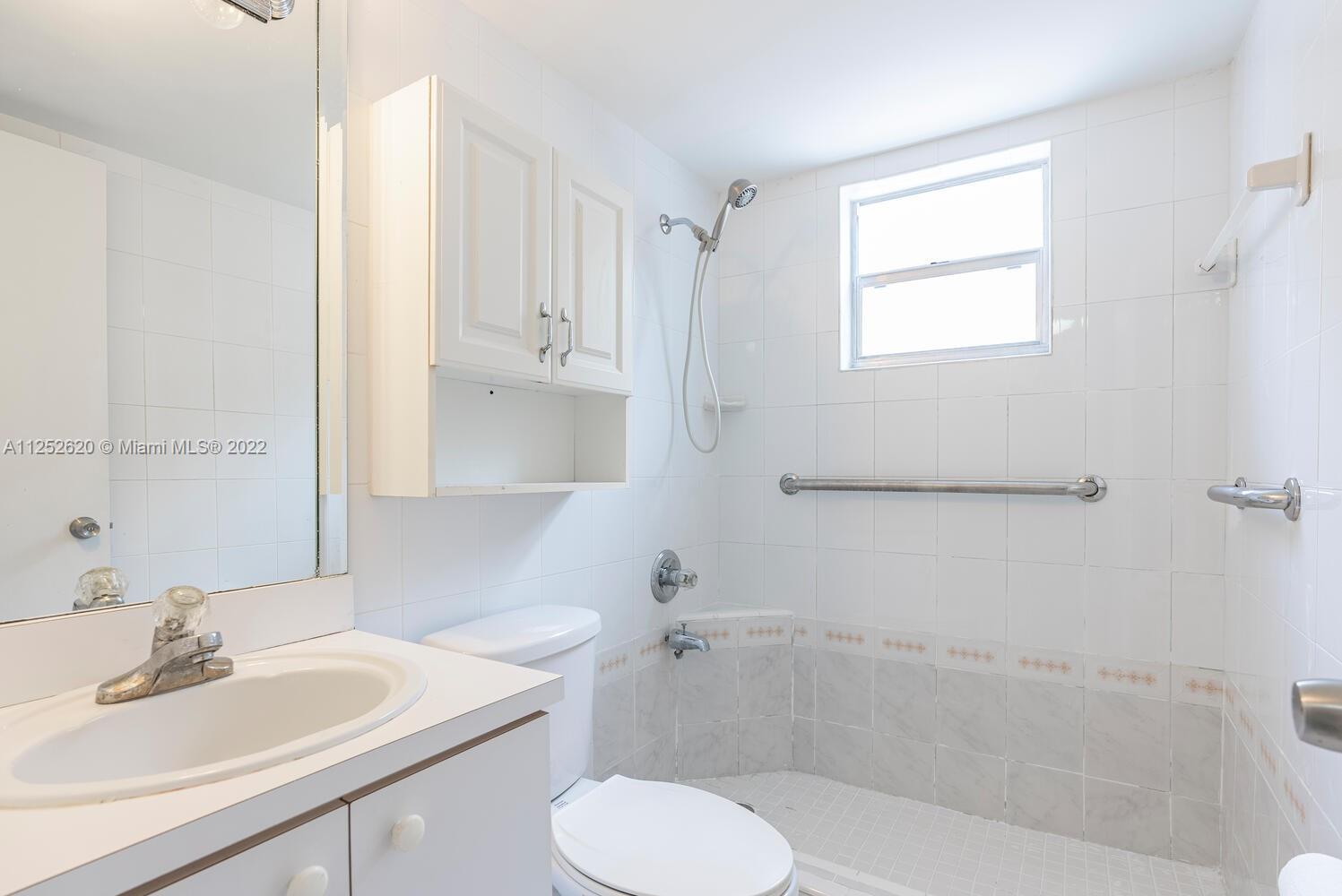1390 Northwest 2nd Street, Unit 2 Miami, FL 33125 - Photo 8 of 10 a bathroom with a sink toilet and tub