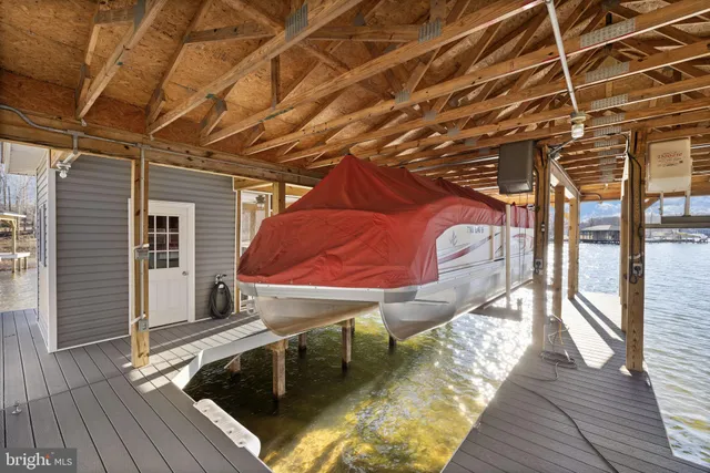 a open kitchen with stainless steel appliances granite countertop a stove top oven a refrigerator and chairs