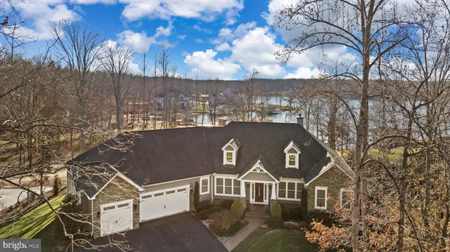 a bedroom with a bed flat screen tv and a large window