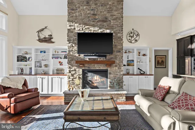 a living room with furniture a dining table and a fireplace