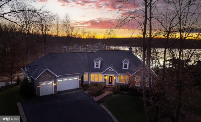 a view of house with swimming pool and outdoor seating