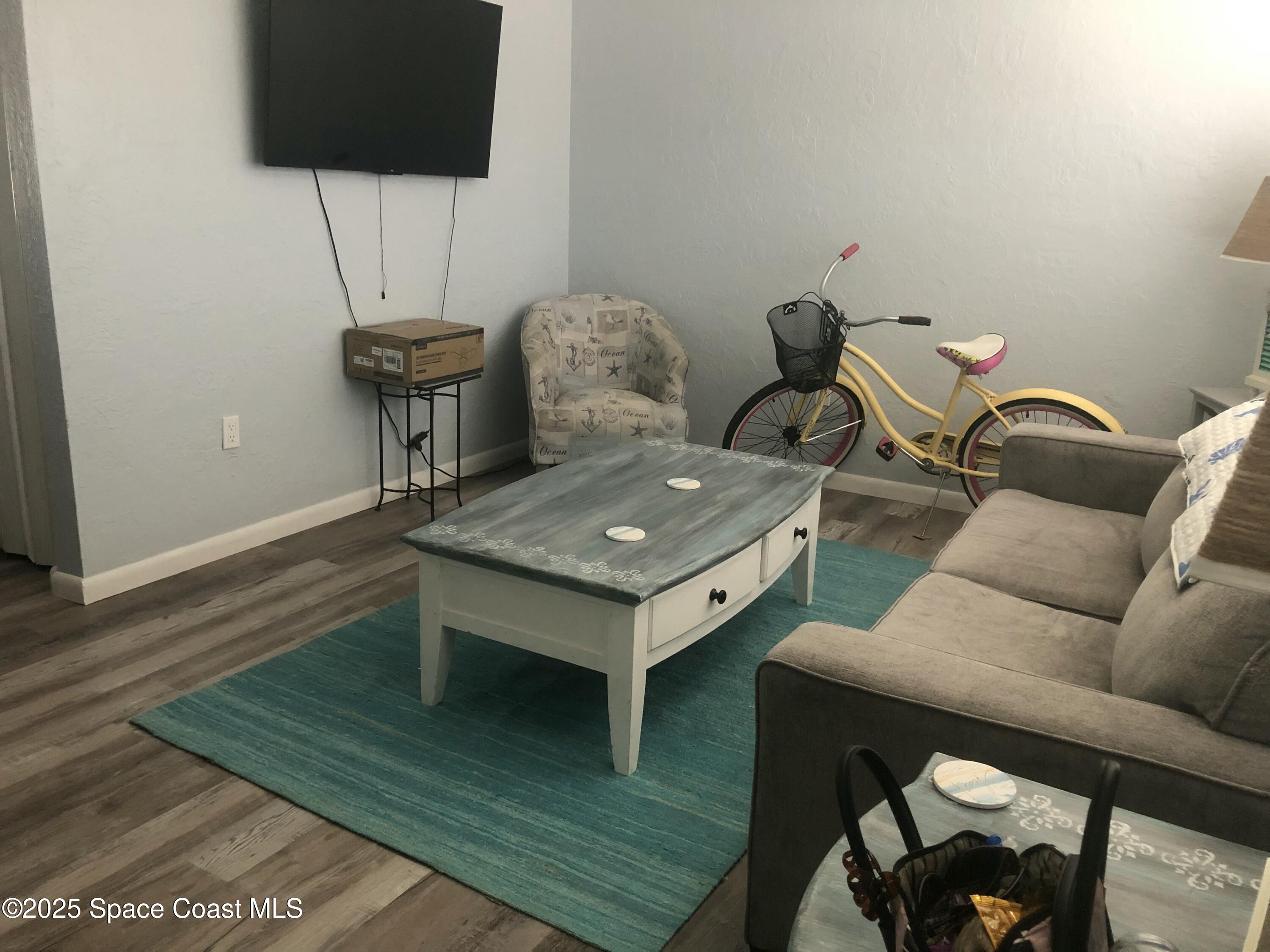 380 North Brevard Avenue, Unit C7 Cocoa Beach, FL 32931 - Photo 3 of 10 a living room with furniture