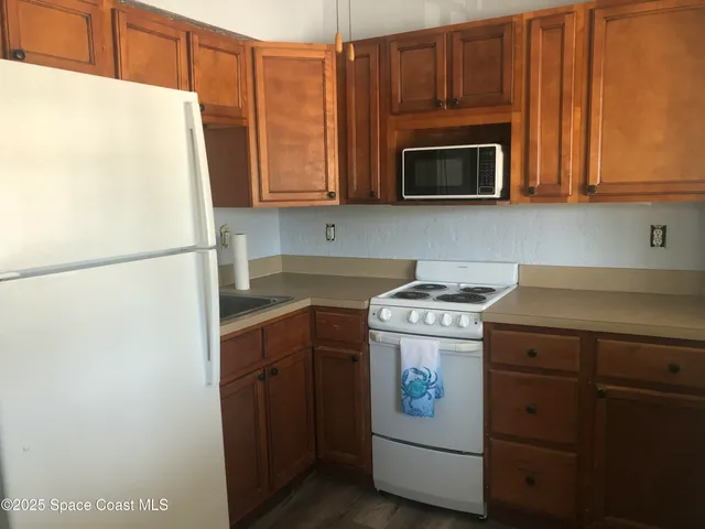 a kitchen with stainless steel appliances a stove a microwave and a refrigerator
