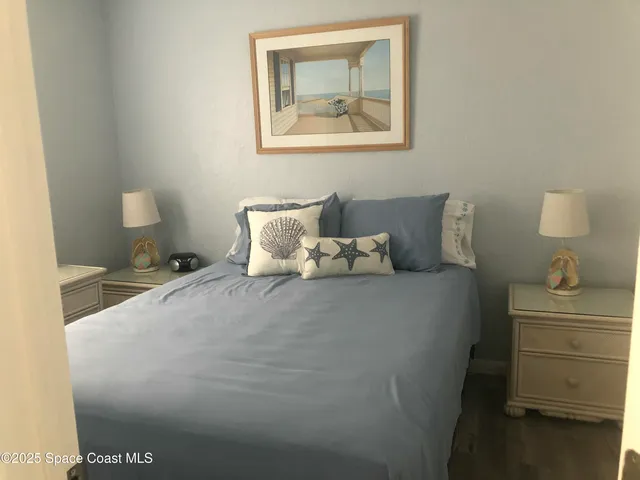 a bedroom with a bed and cabinet