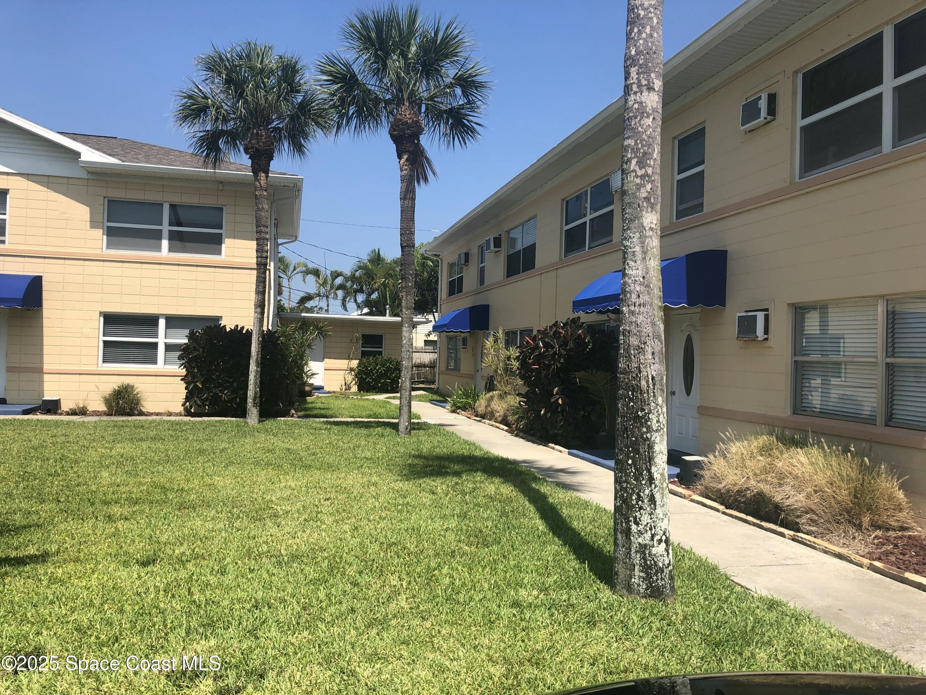 380 North Brevard Avenue, Unit C7 Cocoa Beach, FL 32931 - Photo 10 of 10 a view of a house with a yard
