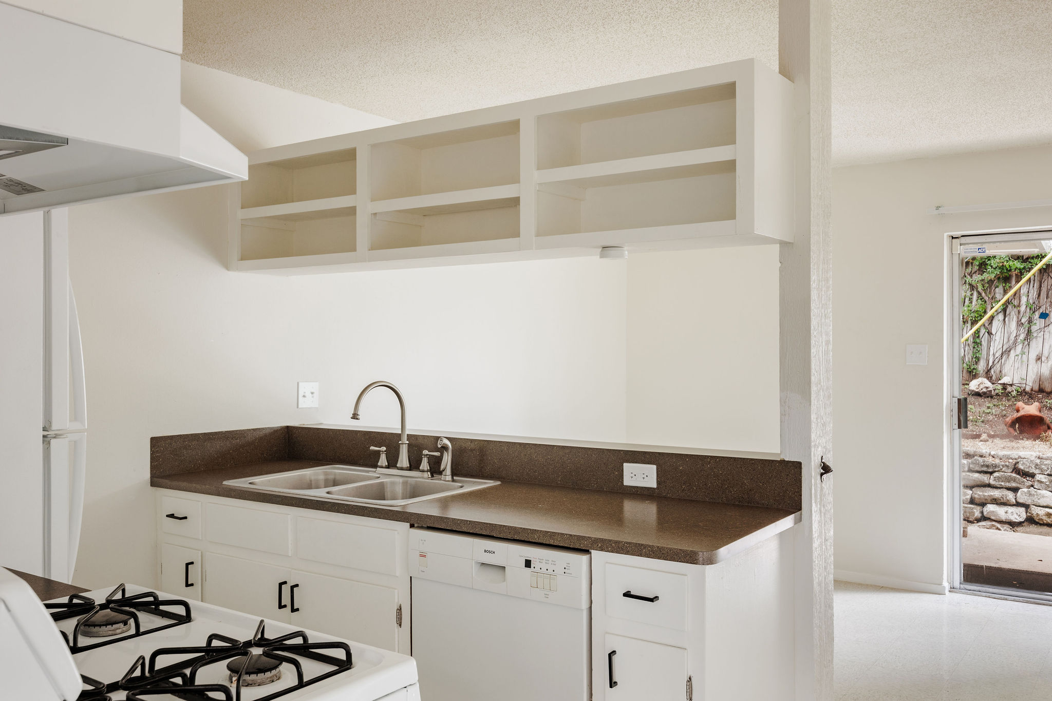 2012 Cody Court Austin, TX 78704 - Photo 32 of 40 A well-equipped kitchen provides essential appliances and direct access to outdoor space.