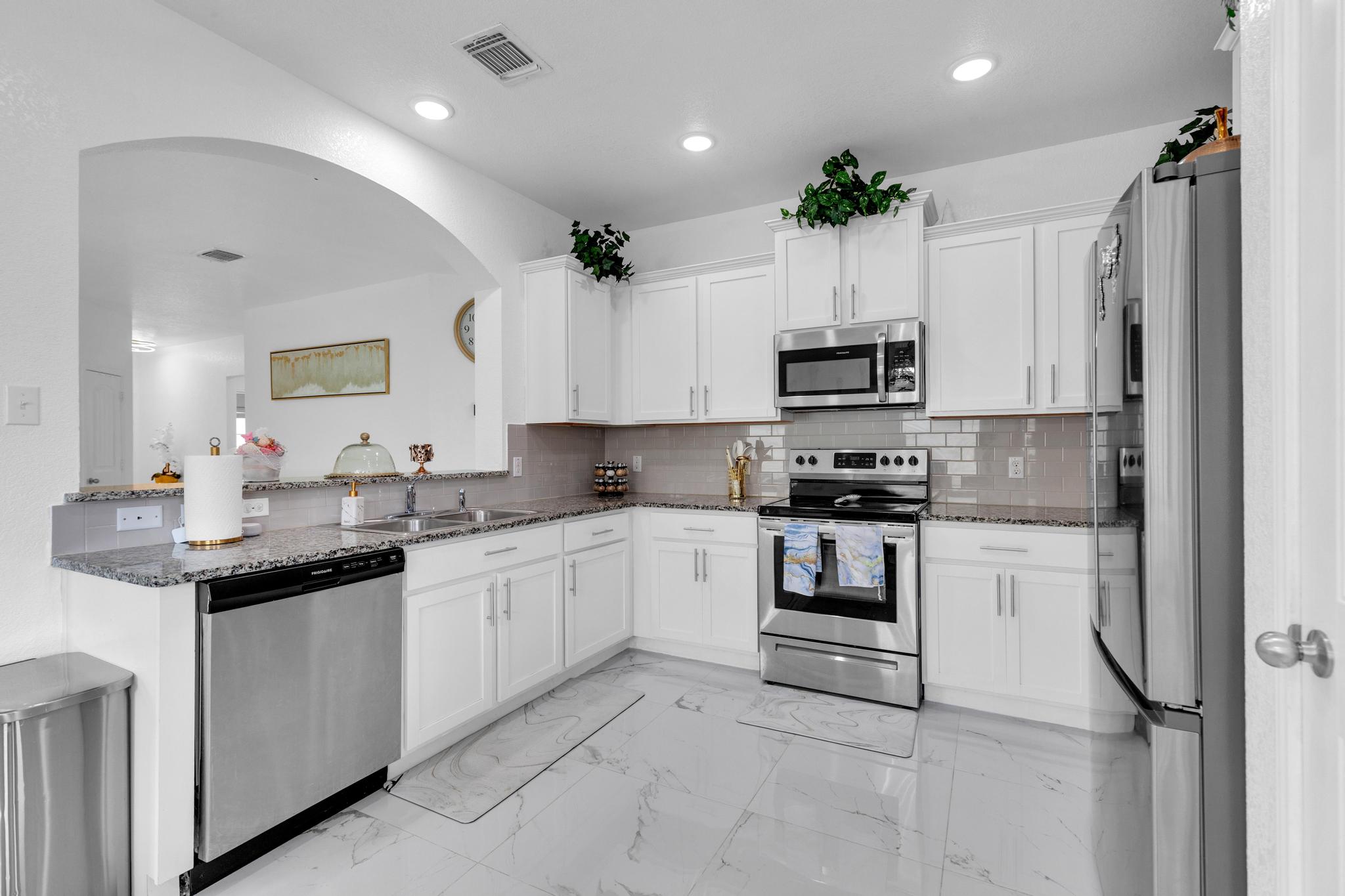119 Beth Ann Loop Taylor, TX 76574 - Photo 13 of 31 A well-appointed kitchen features stainless steel appliances, granite countertops, and sleek cabinetry for optimal function.