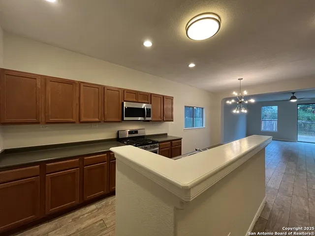 a kitchen with furniture a sink and a stove