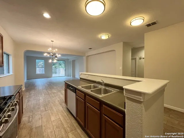 a kitchen that has a sink and a stove in it