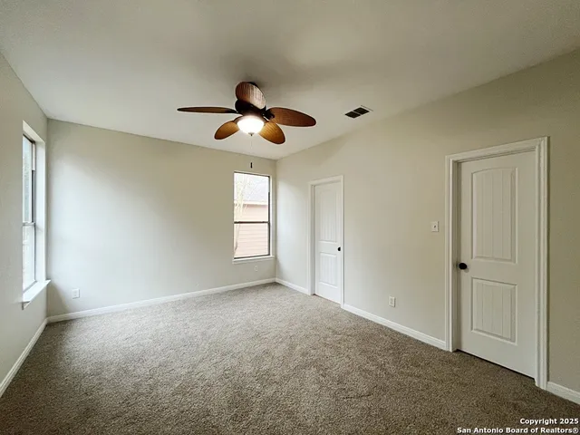 a view of room ceiling fan and entryway