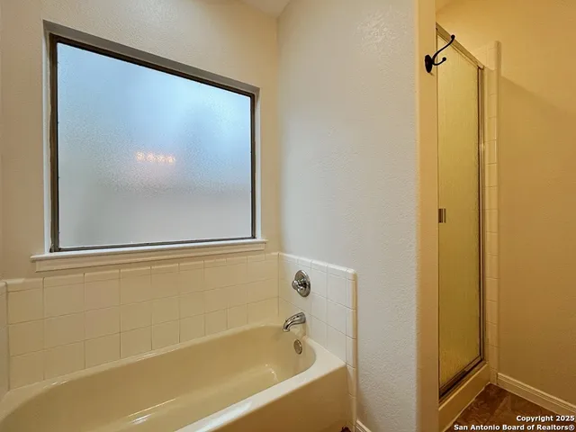 a bathroom with a bathtub and shower