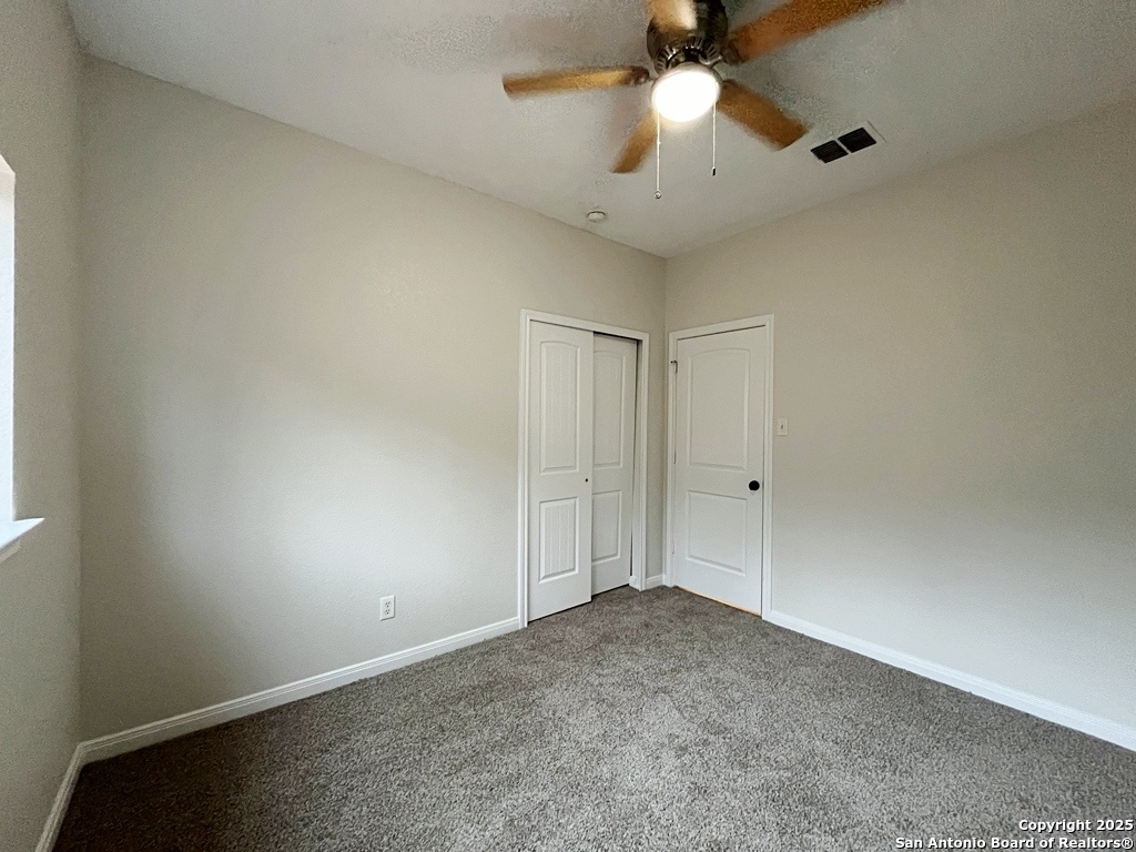 317 Sandy Shoal Boerne, TX 78006 - Photo 26 of 50 an empty room with a ceiling fan and a window