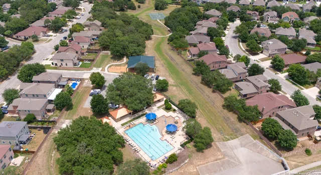 an aerial view of a house with garden space and lake view