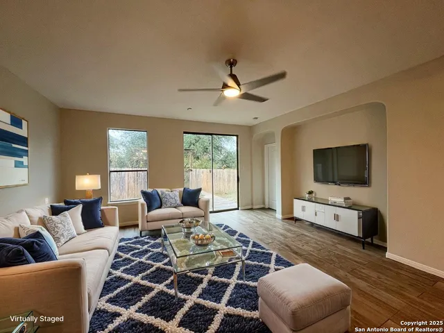 a living room with furniture and a flat screen tv