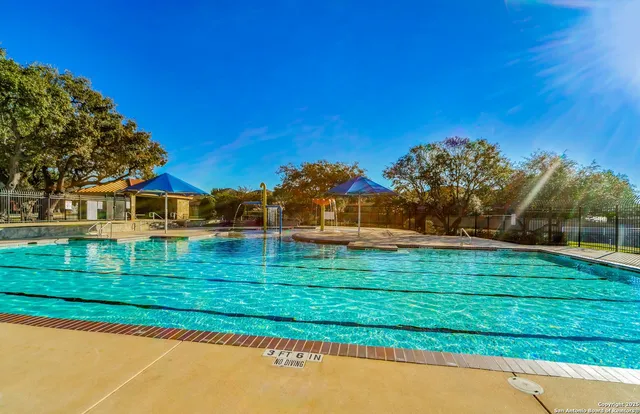 a view of swimming pool with seating space