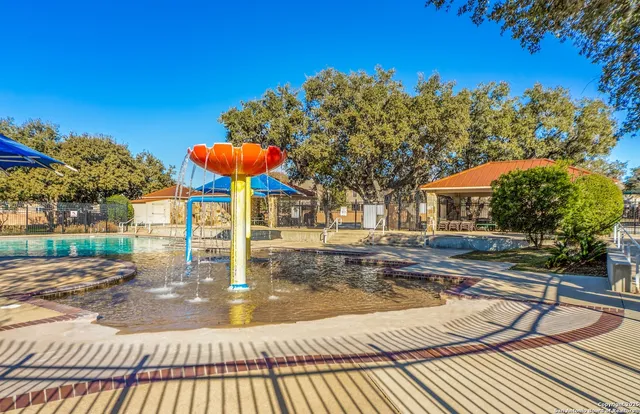 a view of a swimming pool with lounge chairs