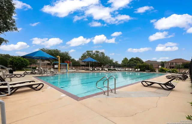 a view of a swimming pool with a patio