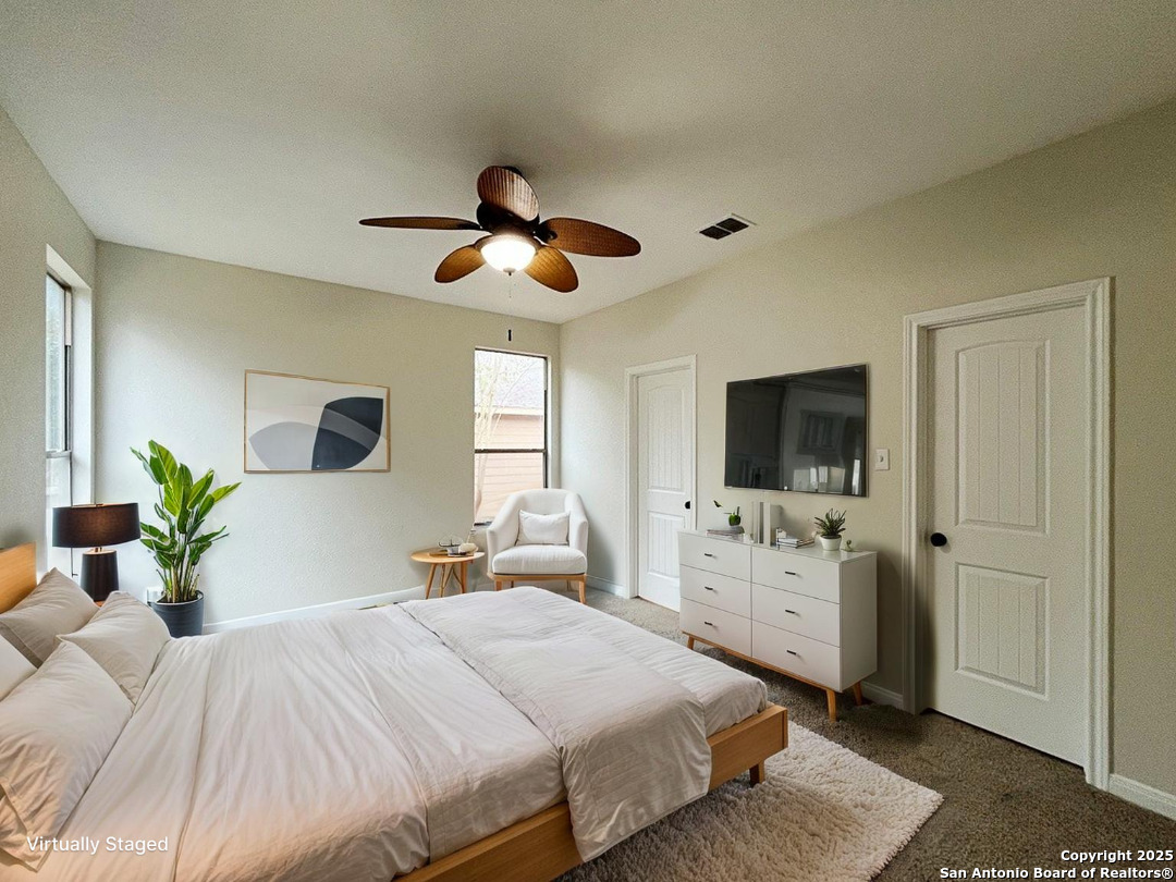 317 Sandy Shoal Boerne, TX 78006 - Photo 5 of 50 a bedroom with a large bed and a flat screen tv