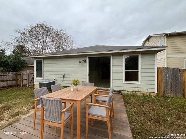 a view of house with a backyard and furniture