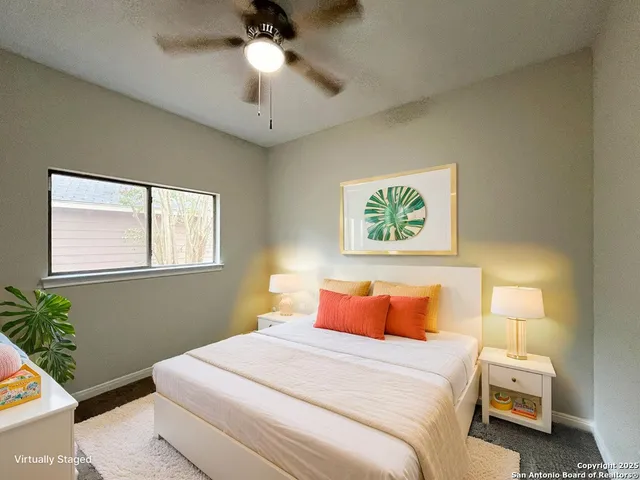 a bedroom with a bed and a potted plant