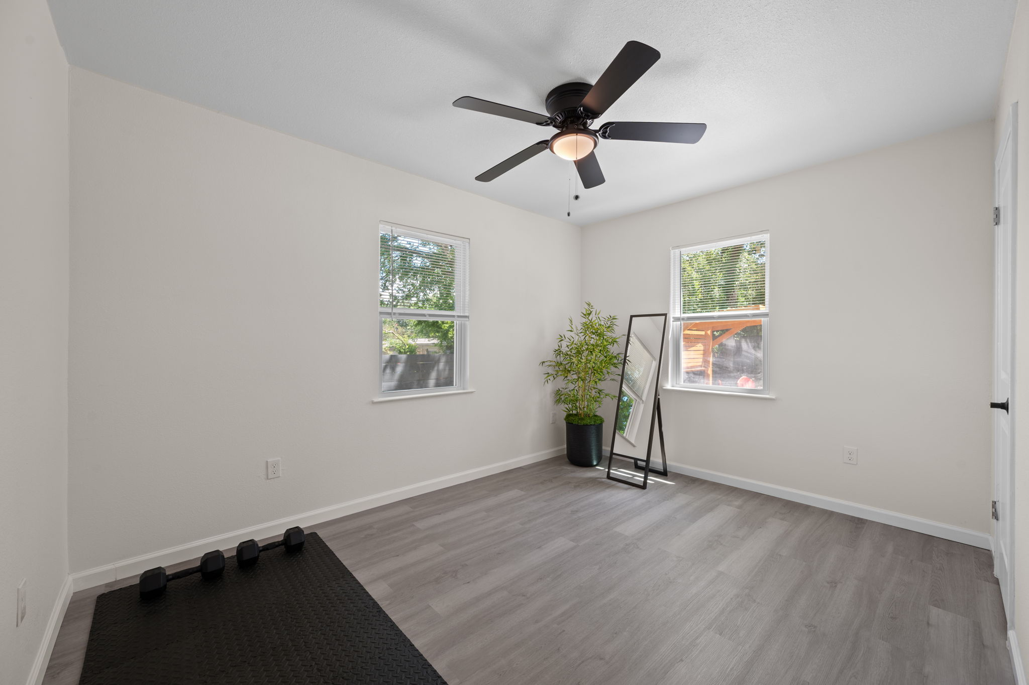 4711 Bandera Road Austin, TX 78721 - Photo 14 of 22 wooden floor in an empty room with a window